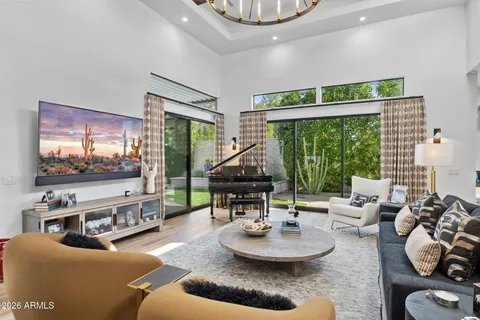 a living room with furniture a fireplace and kitchen view