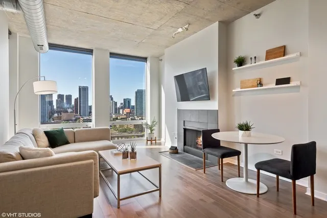 a living room with furniture a fireplace and a flat screen tv