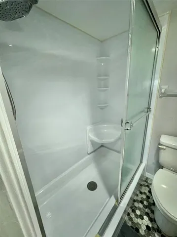 a bathroom with a tub and toilet