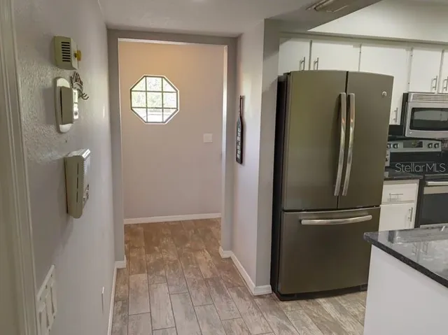 a metallic refrigerator freezer sitting in a kitchen