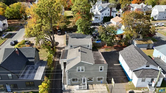 an aerial view of multiple houses with yard