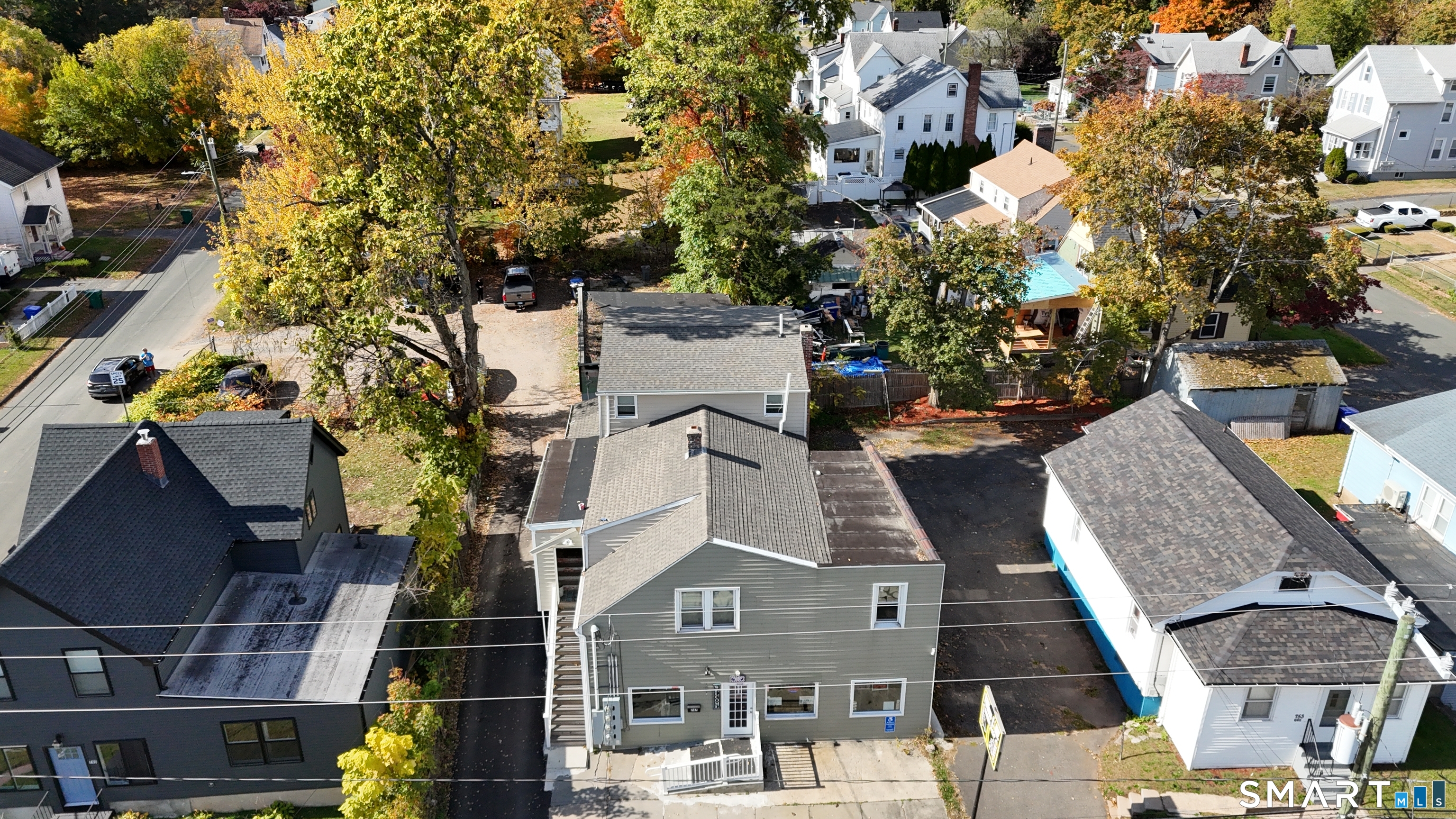 an aerial view of multiple houses with yard