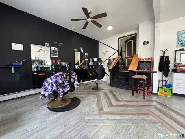 a living room with furniture chess floor and ceiling fan