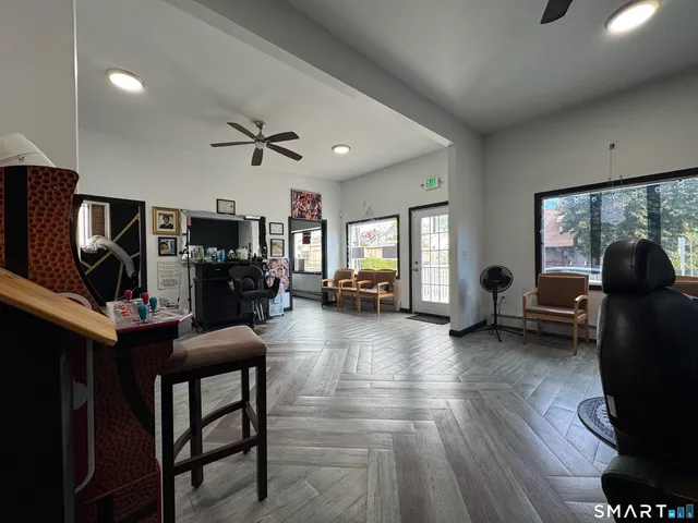 a living room with furniture a fireplace and a large window