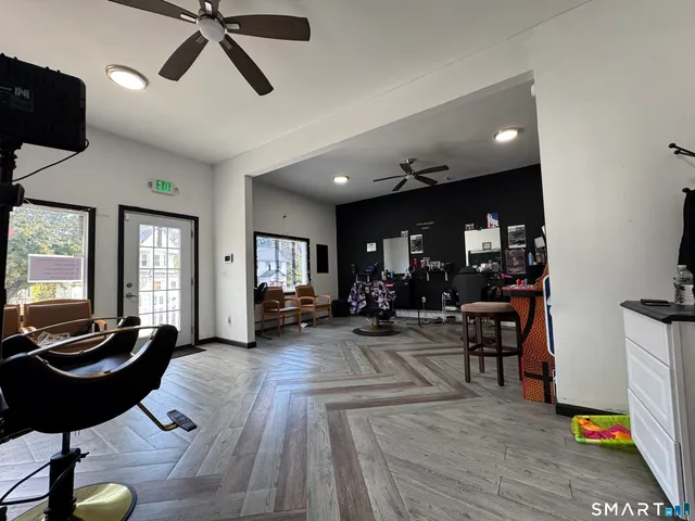 a living room with furniture a rug and a large window