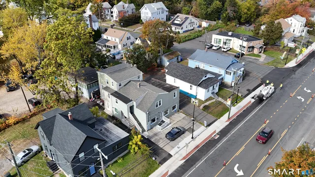 an aerial view of a residential apartment building with swimming pool and lawn chairs