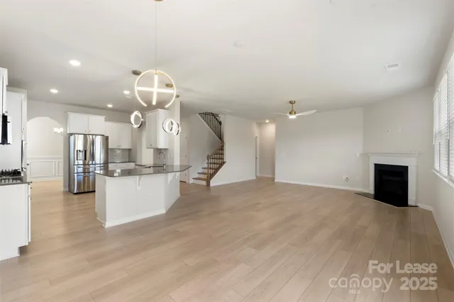 a view of a living room and kitchen with fireplace