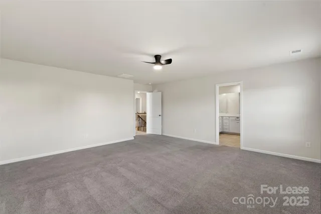 a view of an empty room with a ceiling fan
