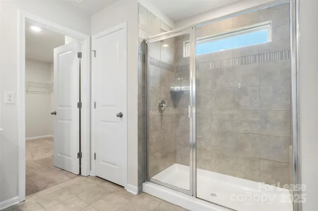 a bathroom with a glass shower door