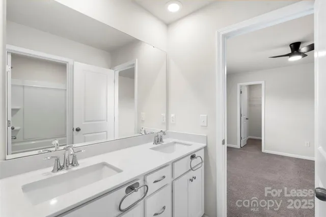 a bathroom with a sink double vanity and a mirror