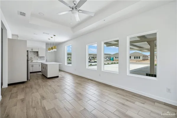 a view of a room with wooden floor and windows