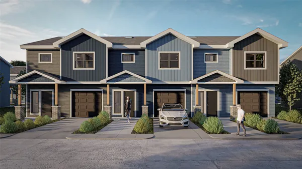 a view of a brick house with large windows and a small yard