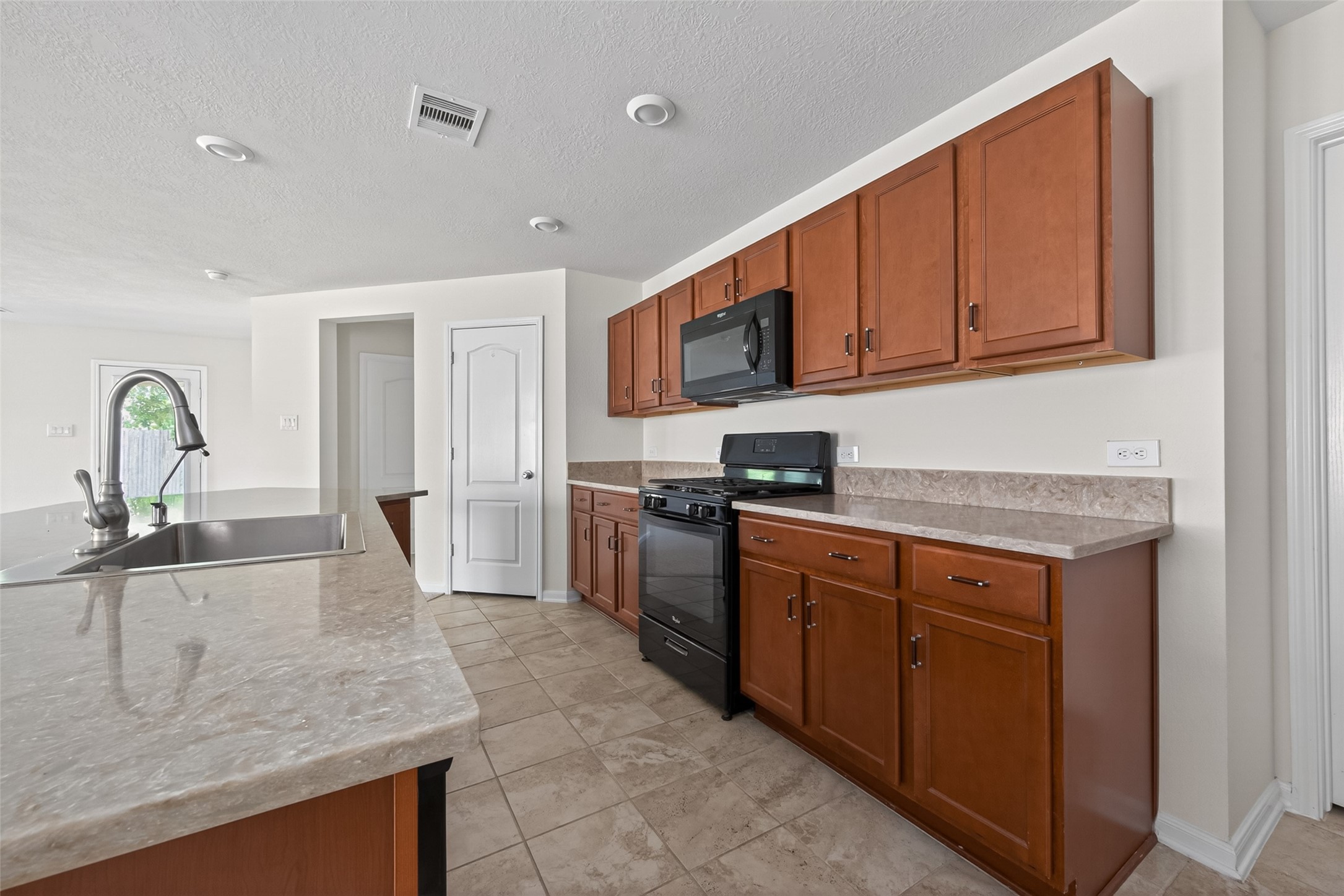 2754 Cayden Creek Way Conroe, TX 77304 - Photo 17 of 40 a kitchen with stainless steel appliances granite countertop a sink dishwasher stove and refrigerator