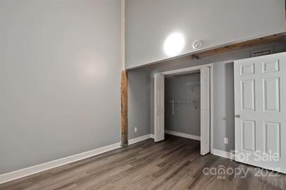 201 South Hoskins Road, Unit 111 Charlotte, NC 28208 - Photo 13 of 16 an empty room with wooden floor & closet area