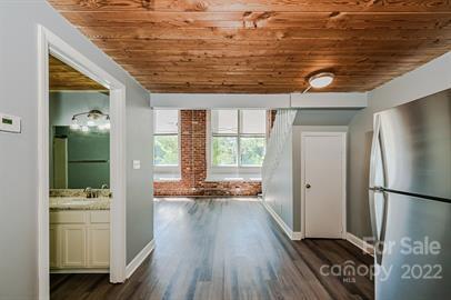 201 South Hoskins Road, Unit 111 Charlotte, NC 28208 - Photo 8 of 16 a view of hallway with furniture and wooden floor