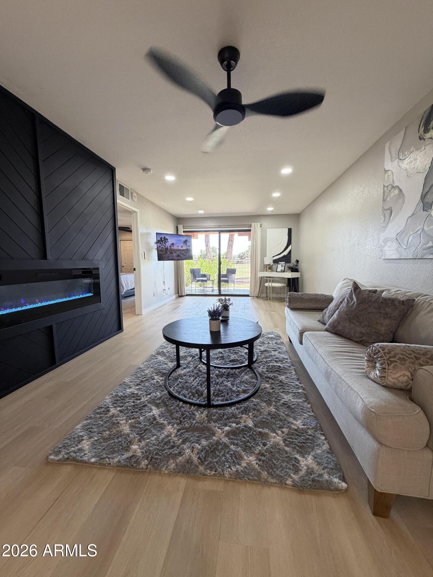 4303 East Cactus Road, Unit 128 Phoenix, AZ 85032 - Photo 36 of 39 a living room with furniture and a kitchen view