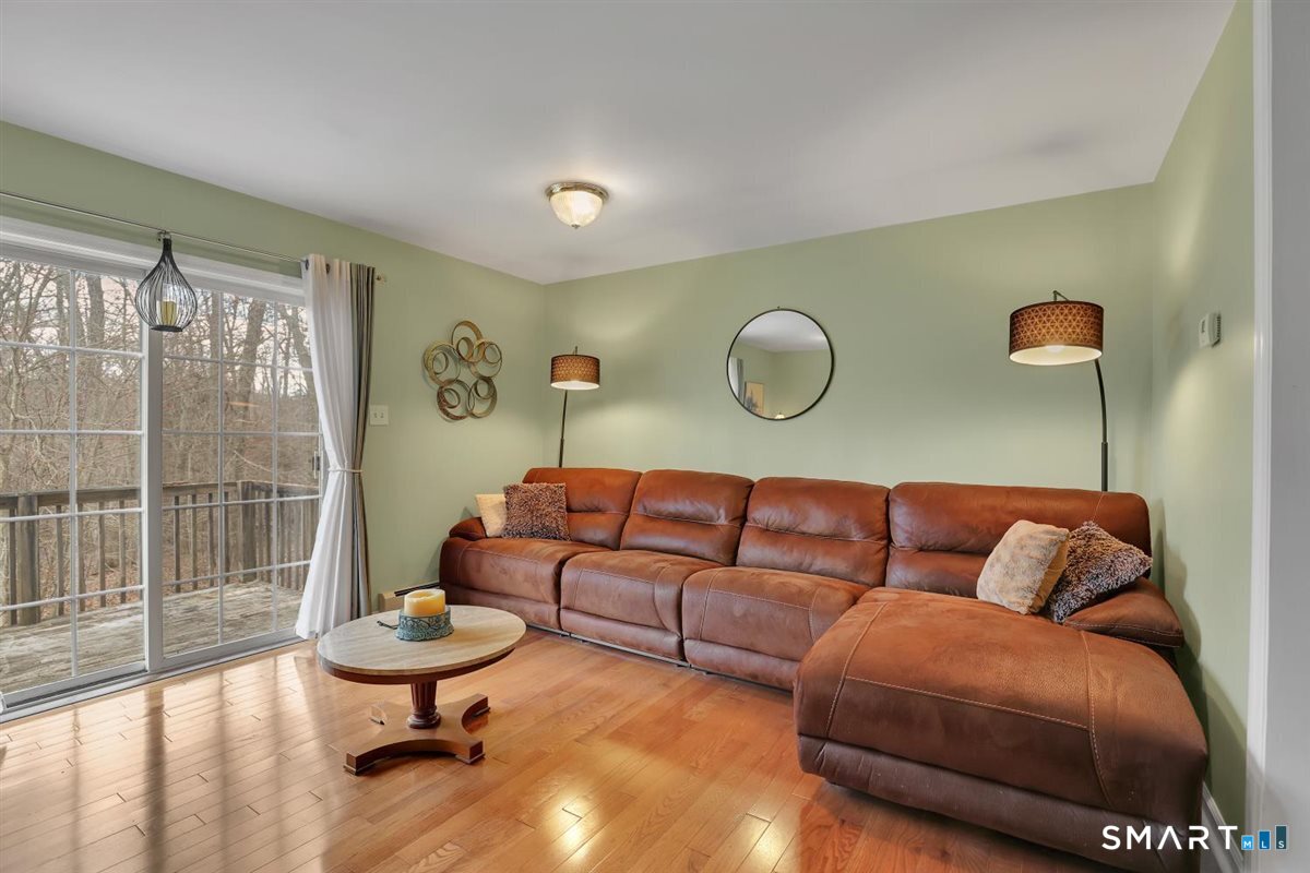 240 Elm Street Old Saybrook, CT 06475 - Photo 12 of 24 a living room with furniture and a potted plant