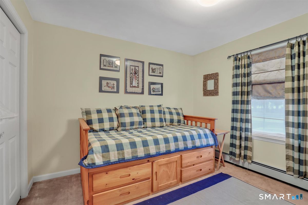 240 Elm Street Old Saybrook, CT 06475 - Photo 13 of 24 a bedroom with a bed and a dresser