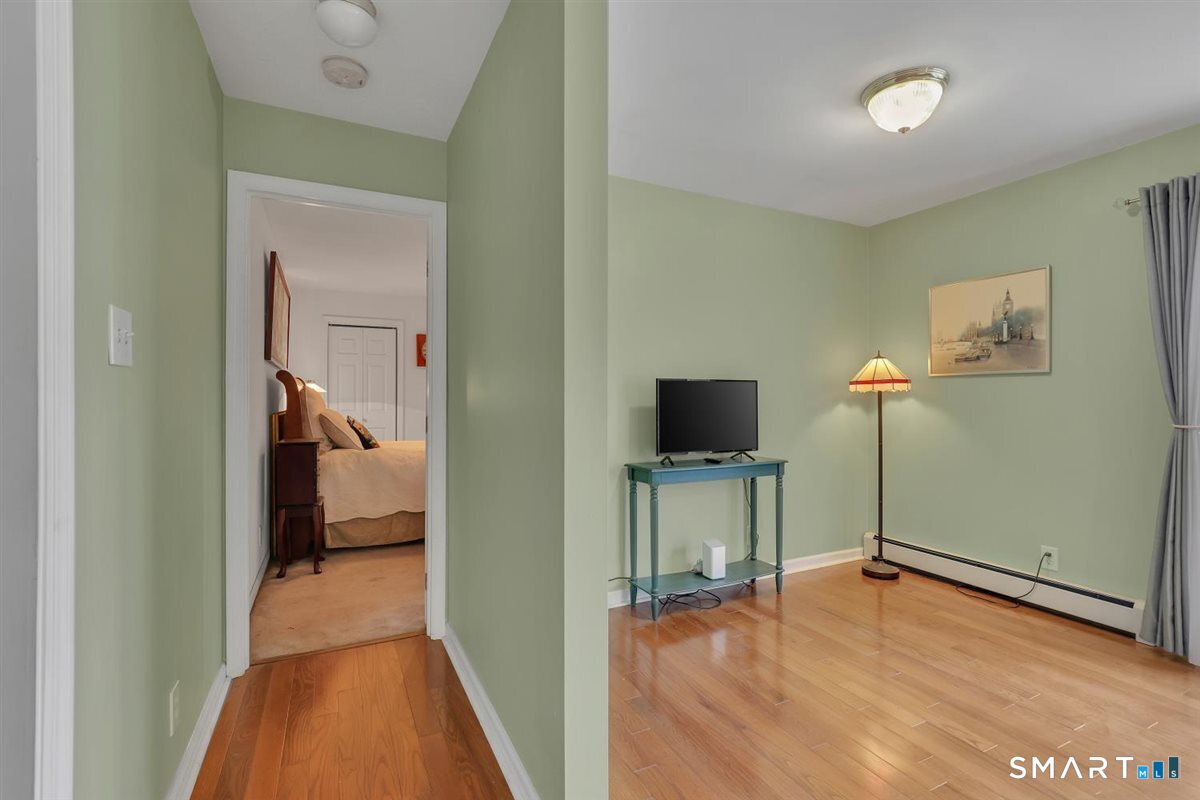 240 Elm Street Old Saybrook, CT 06475 - Photo 16 of 24 a view of a room with a flat tv screen and wooden floor