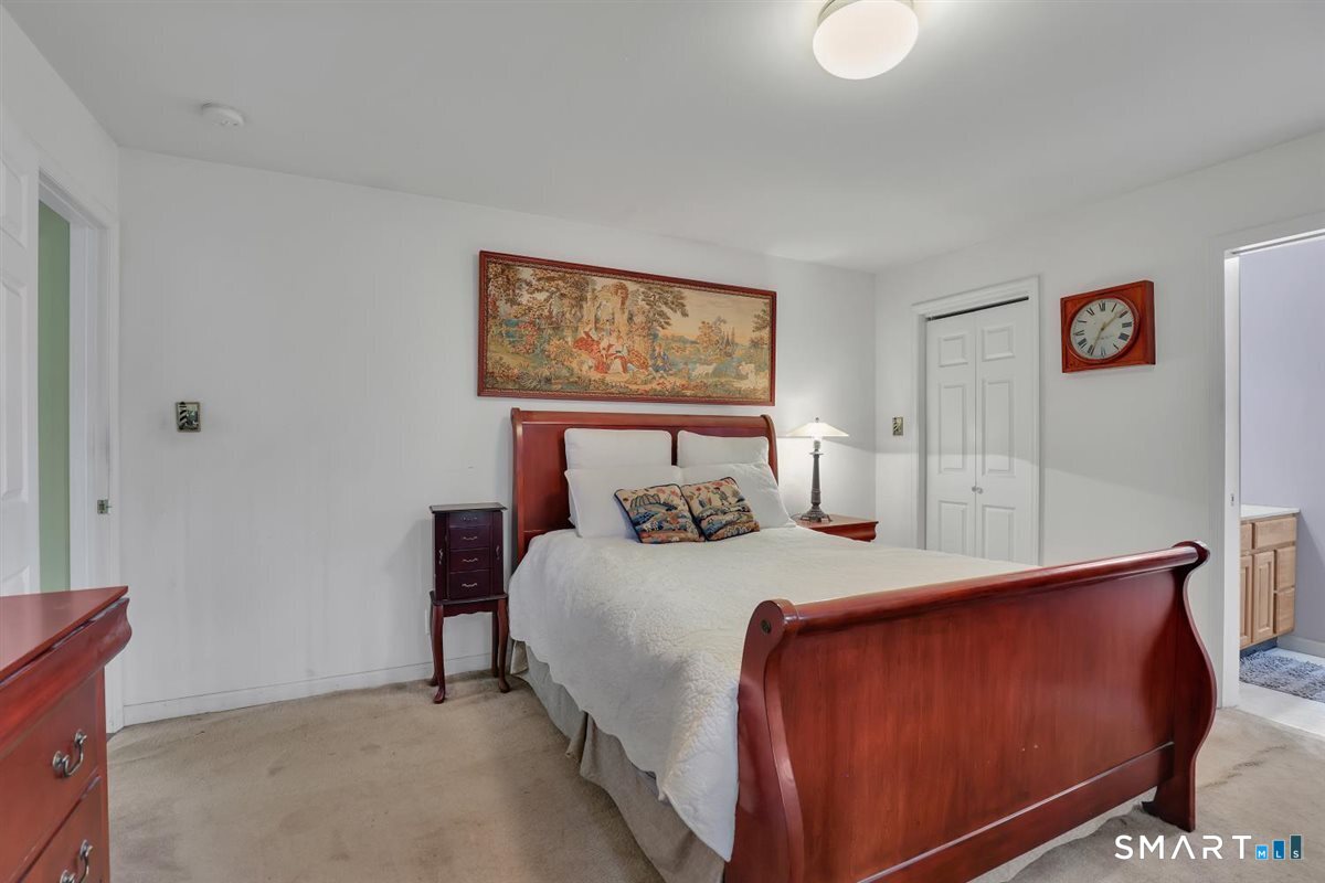 240 Elm Street Old Saybrook, CT 06475 - Photo 17 of 24 a bedroom with a bed and painting on the wall