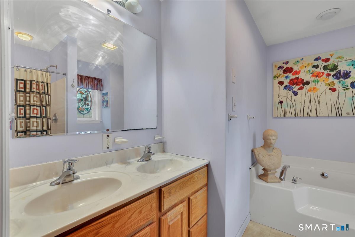 240 Elm Street Old Saybrook, CT 06475 - Photo 18 of 24 a bathroom with a tub sink and mirror