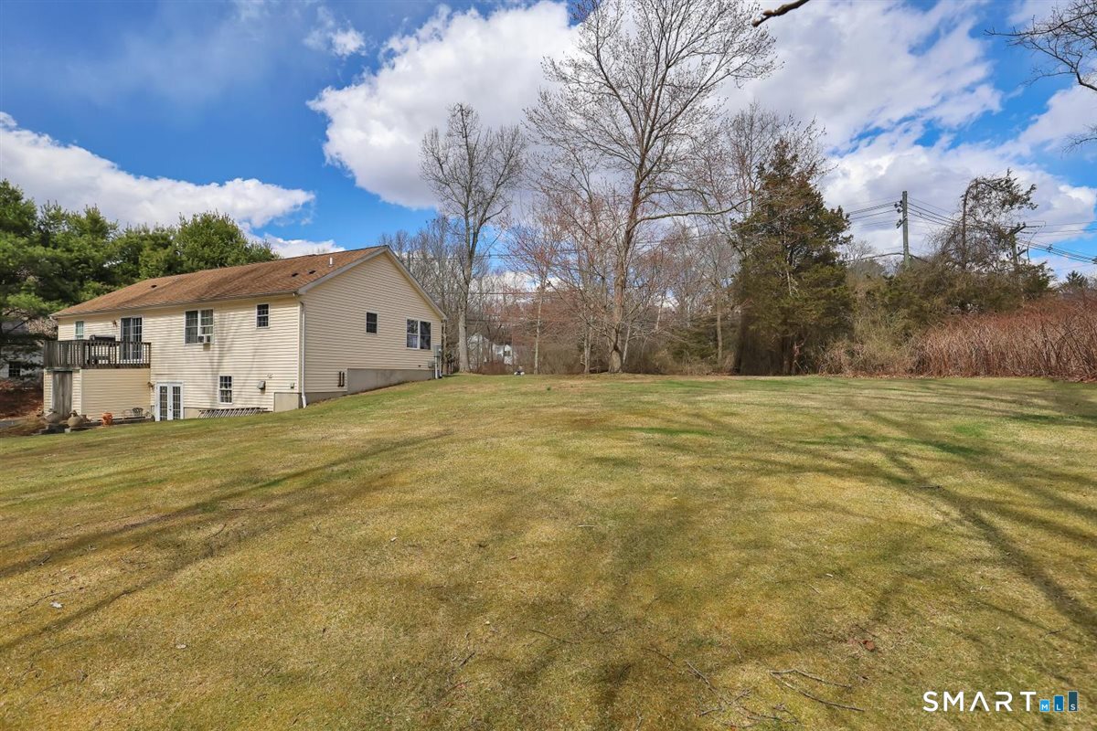 240 Elm Street Old Saybrook, CT 06475 - Photo 23 of 24 a view of a large white house with a large tree with wooden fence