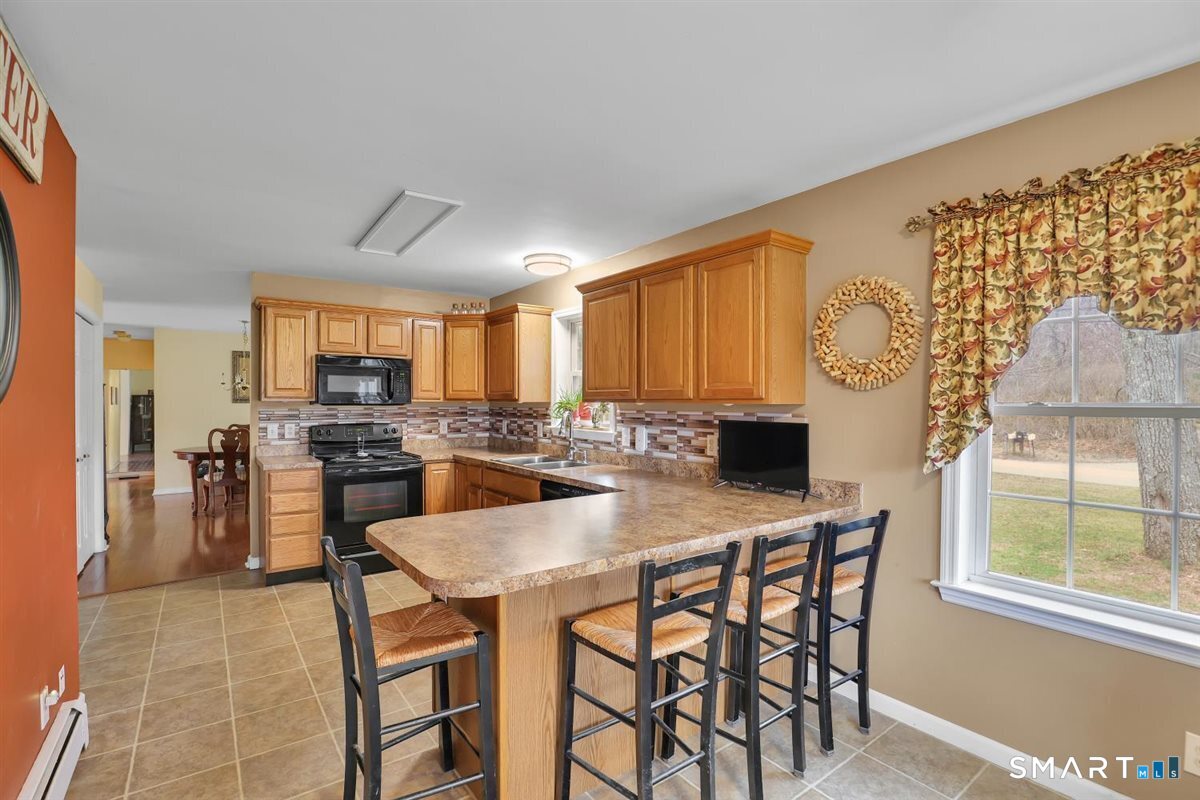240 Elm Street Old Saybrook, CT 06475 - Photo 8 of 24 a view of a dining room with furniture and a table