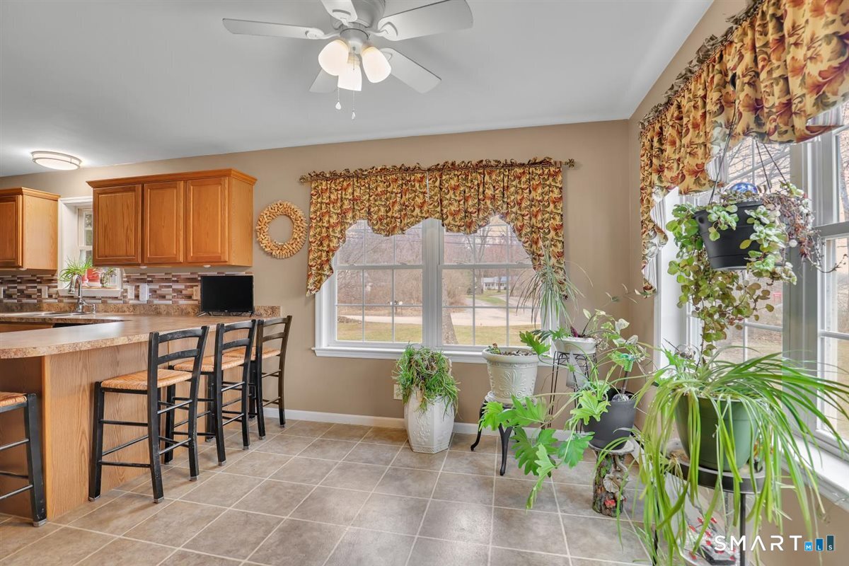 240 Elm Street Old Saybrook, CT 06475 - Photo 9 of 24 a kitchen with a table and chairs in it