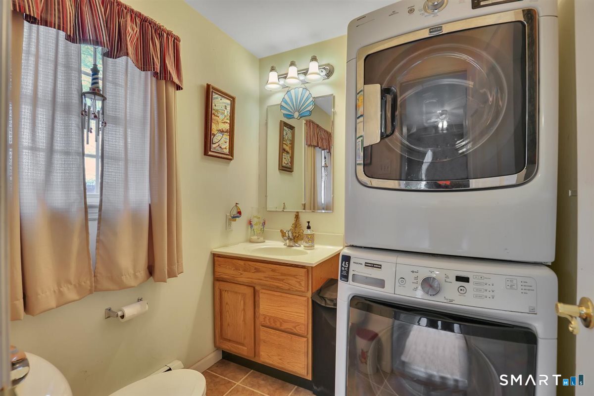 240 Elm Street Old Saybrook, CT 06475 - Photo 10 of 24 a bathroom with a sink a toilet and a mirror
