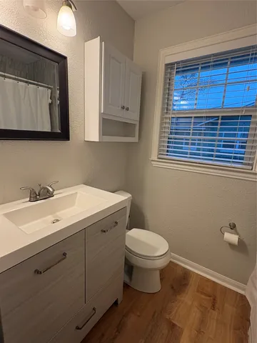 a bathroom with a toilet sink and mirror