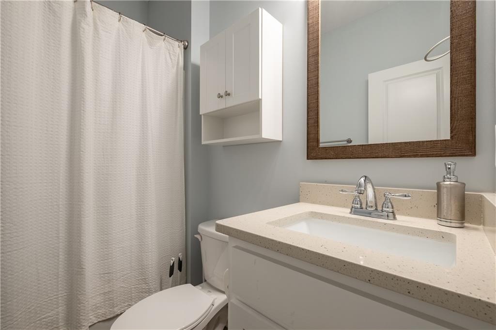 719 Fairview Road Brooks, GA 30205 - Photo 17 of 35 a bathroom with a sink a toilet and mirror
