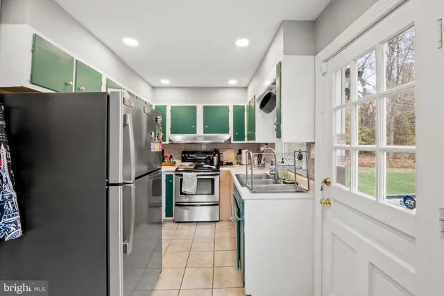 a kitchen with a refrigerator a sink and cabinets