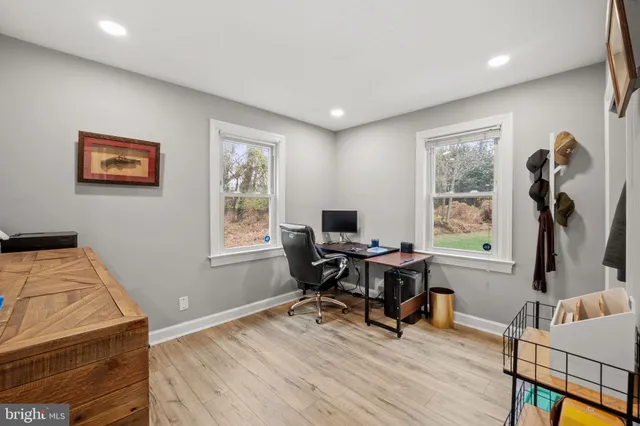 a view of a workspace with furniture and a window