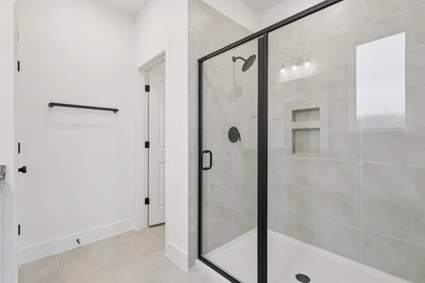 a bathroom with a glass shower door and a sink