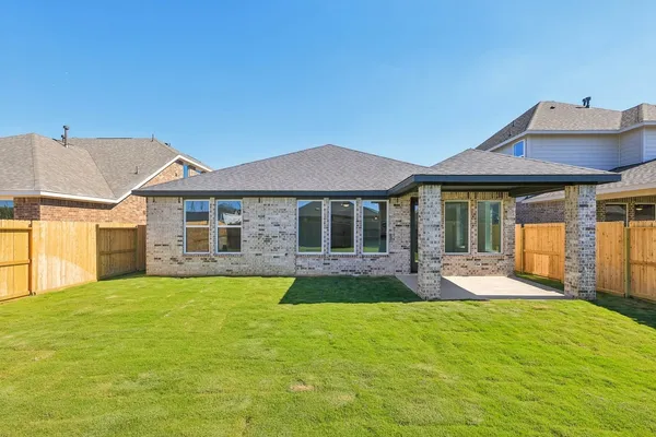 a view of a house with a yard and sitting area