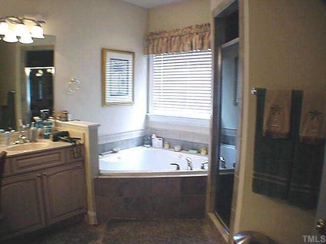 12321 Beestone Lane Raleigh, NC 27614 - Photo 6 of 10 The Master Bath features custom glazed cabinets, upgraded tilework, a separate shower and whirlpool tub Other