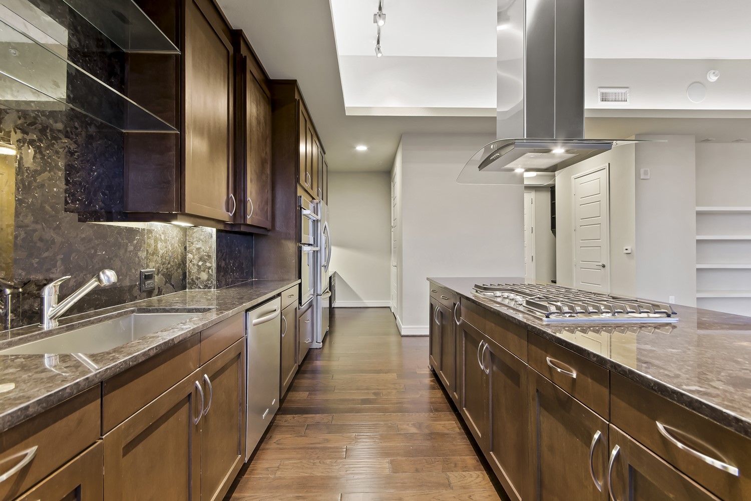 214 Barton Springs Road, Unit 1909 Austin, TX 78704 - Photo 18 of 34 Kitchen with dark stone counters, open shelves, island exhaust hood, dark wood-style flooring, and recessed lighting