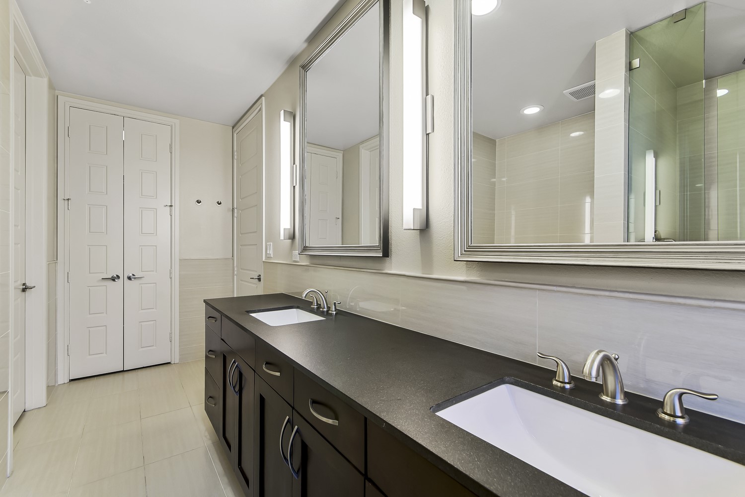 214 Barton Springs Road, Unit 1909 Austin, TX 78704 - Photo 2 of 34 Bathroom featuring double vanity, a shower stall, and tasteful backsplash