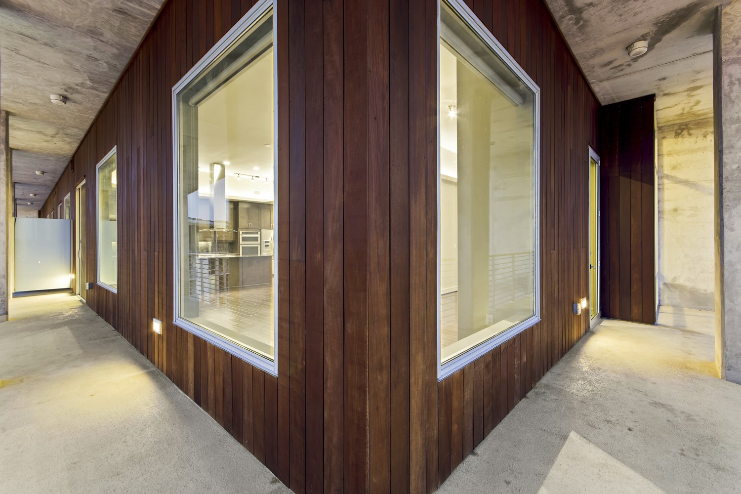 214 Barton Springs Road, Unit 1909 Austin, TX 78704 - Photo 33 of 34 Hall with wooden walls and light colored carpet