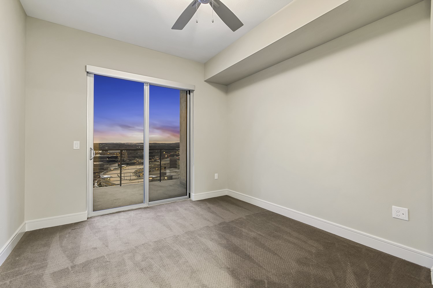 214 Barton Springs Road, Unit 1909 Austin, TX 78704 - Photo 7 of 34 Spare room featuring light colored carpet and ceiling fan
