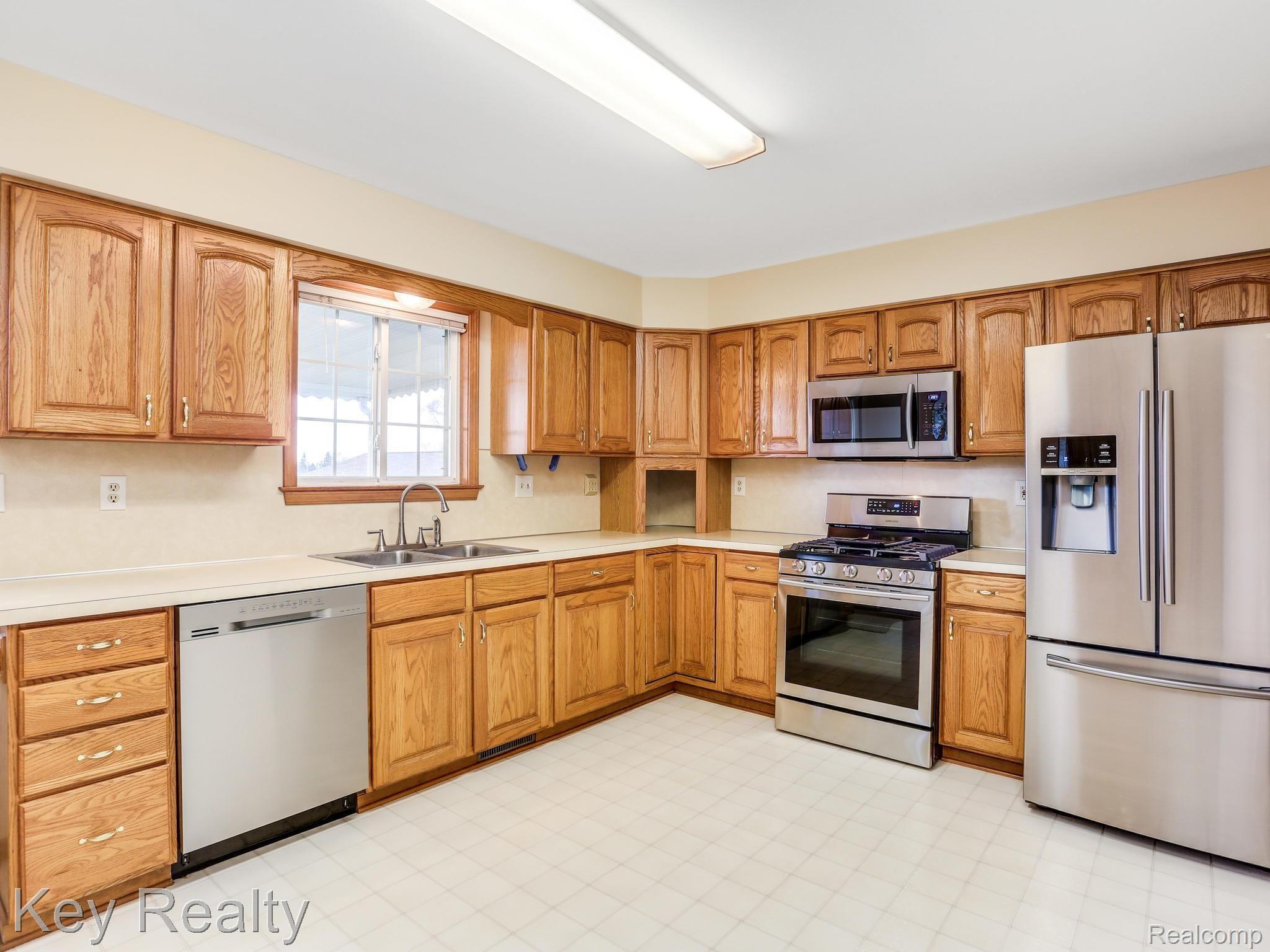 4048 Morrish Road Swartz Creek, MI 48473 - Photo 10 of 40 Large upper level kitchen with BRAND NEW stainless steel appliances!