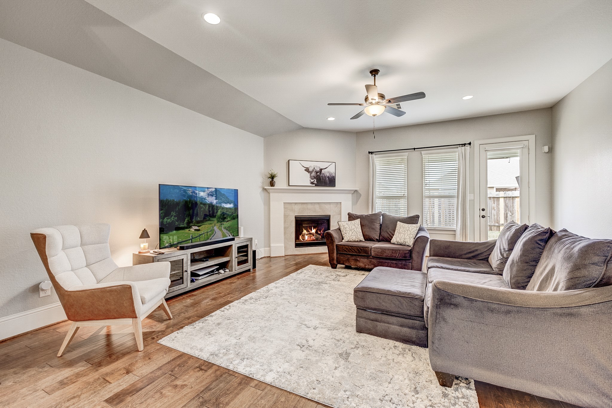 29522 Monona Terrace Court Spring, TX 77386 - Photo 31 of 44 a living room with furniture a flat screen tv and a fireplace
