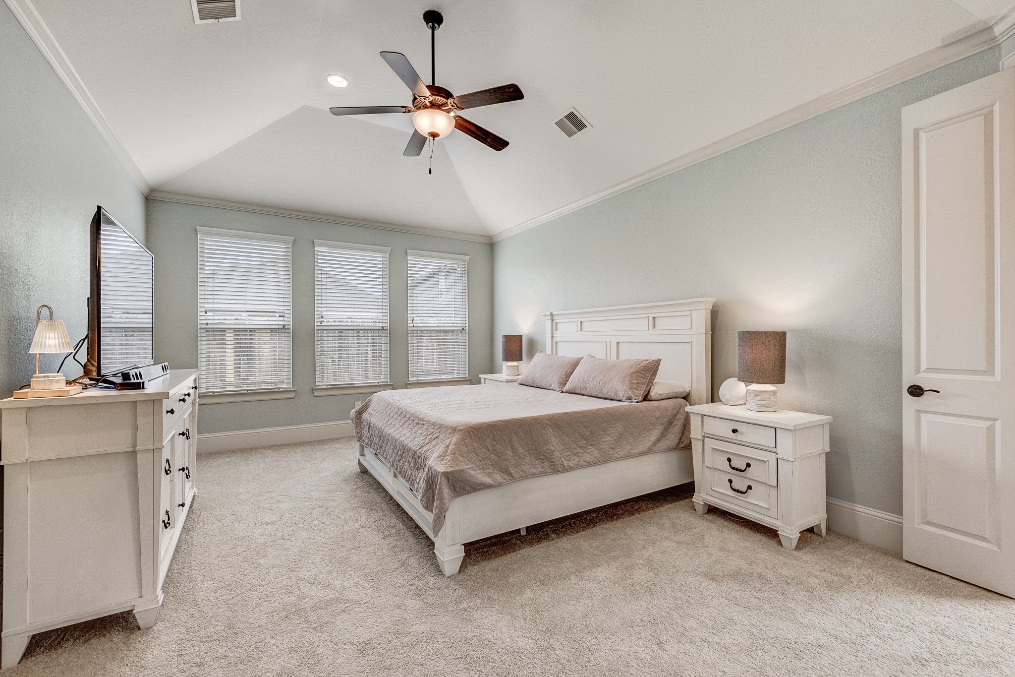 29522 Monona Terrace Court Spring, TX 77386 - Photo 35 of 44 a spacious bedroom with a bed and a chandelier