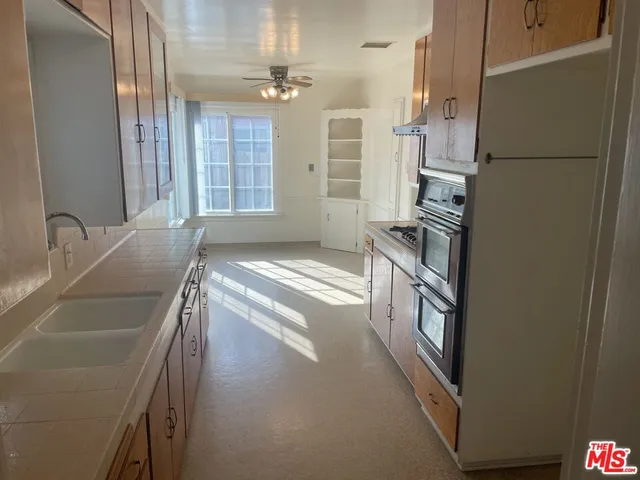 a view of a kitchen with a sink and dishwasher a refrigerator
