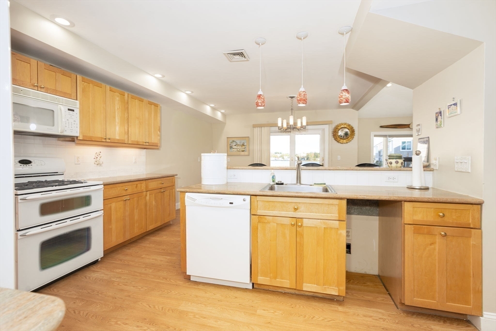 19 Harbourside Road, Unit 19 Quincy, MA 02171 - Photo 13 of 41 a kitchen with a sink stove and cabinets