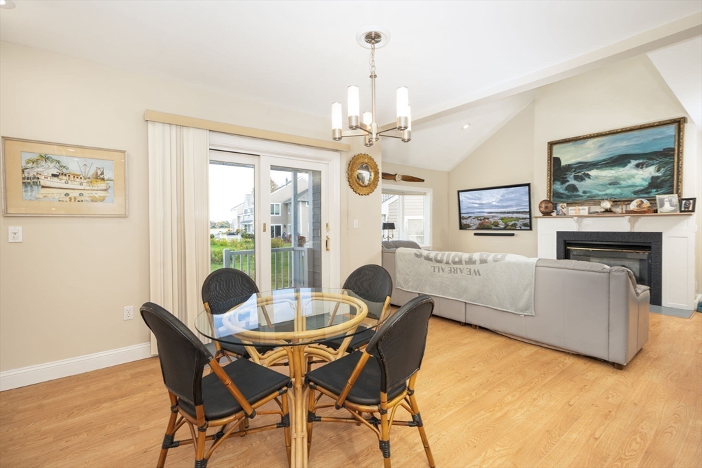 19 Harbourside Road, Unit 19 Quincy, MA 02171 - Photo 15 of 41 a view of a dining room with furniture a chandelier and wooden floor