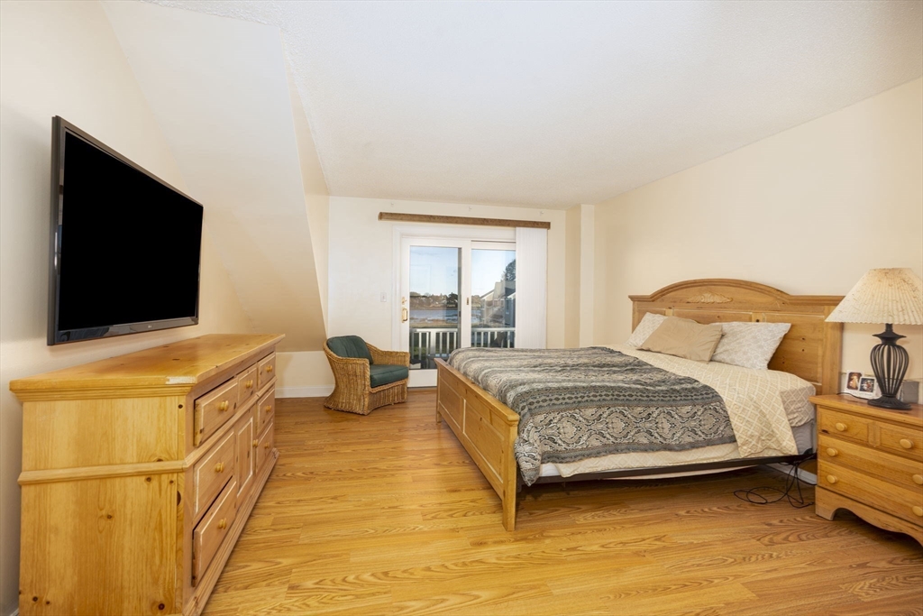 19 Harbourside Road, Unit 19 Quincy, MA 02171 - Photo 21 of 41 a bedroom with a bed and a flat screen tv