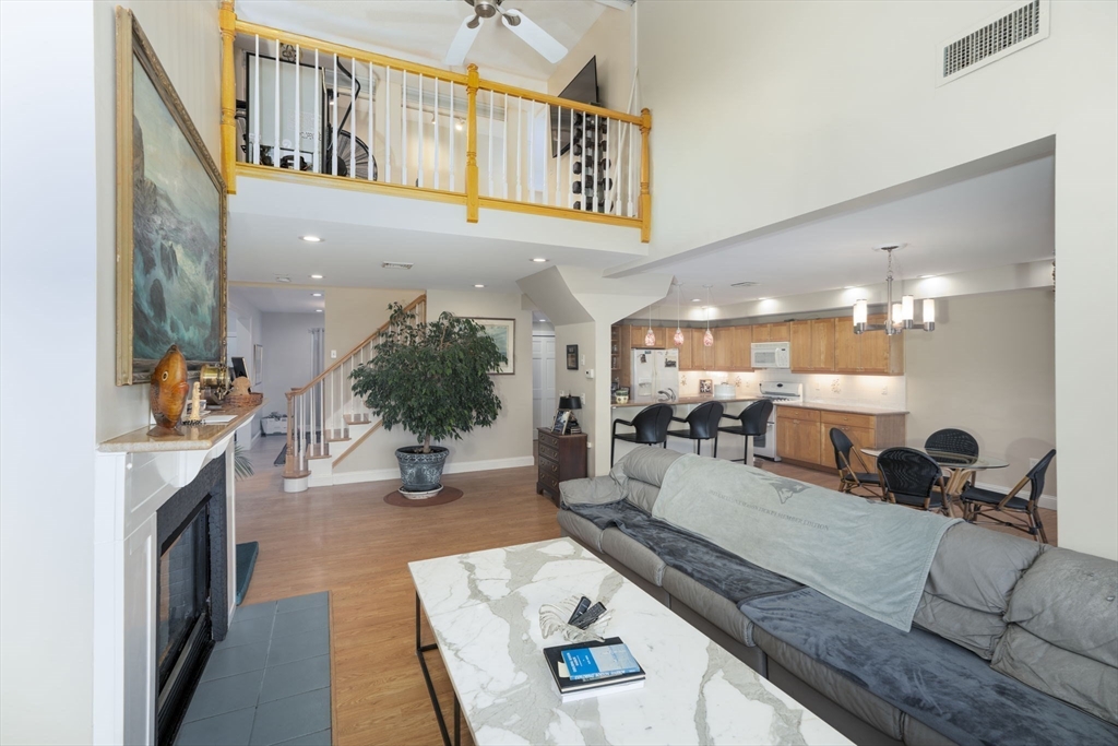 19 Harbourside Road, Unit 19 Quincy, MA 02171 - Photo 7 of 41 a living room with furniture a fireplace and potted plant