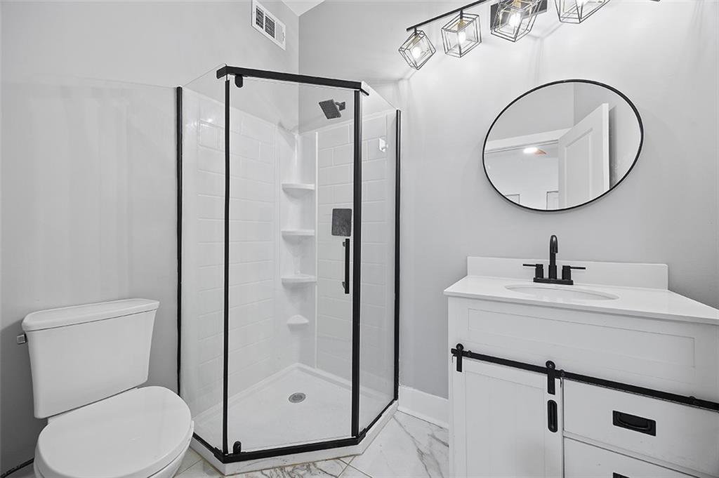 1109 East Carson Street Pittsburgh, PA 15203 - Photo 11 of 13 a bathroom with a sink toilet and a mirror