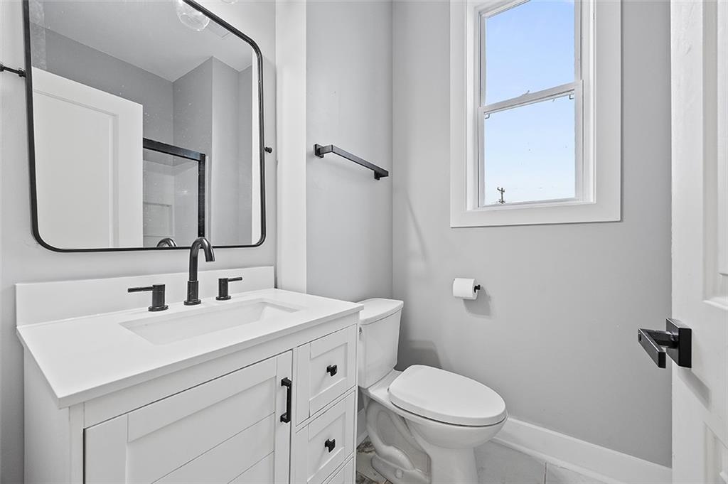 1109 East Carson Street Pittsburgh, PA 15203 - Photo 12 of 13 a bathroom with a toilet sink and mirror